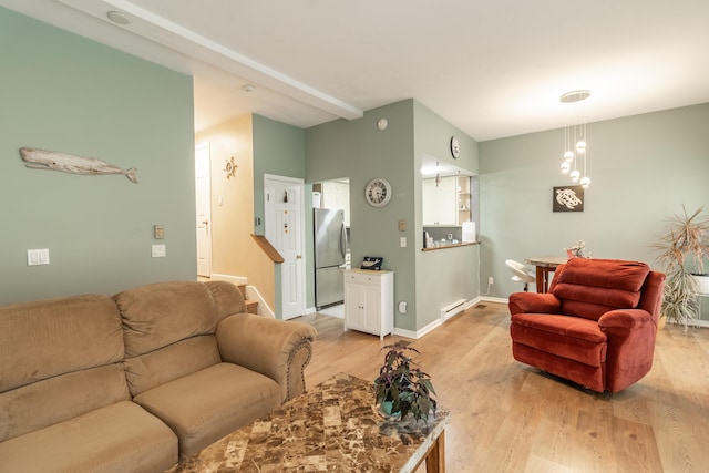 living area with light wood-style floors, baseboards, and baseboard heating