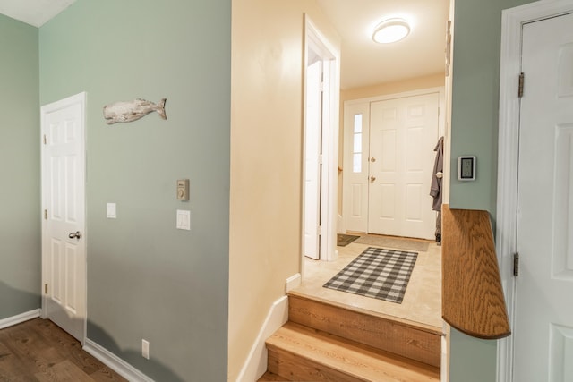 hall featuring baseboards and wood finished floors