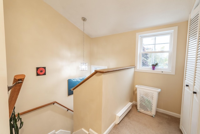 stairs with carpet, a baseboard radiator, and baseboards