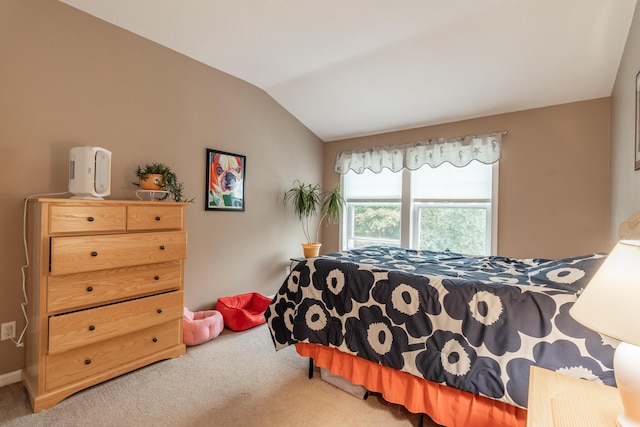 bedroom with carpet floors and vaulted ceiling