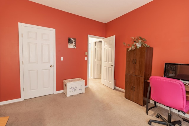 carpeted home office with baseboards