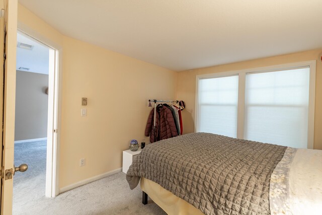 bedroom featuring carpet floors and baseboards