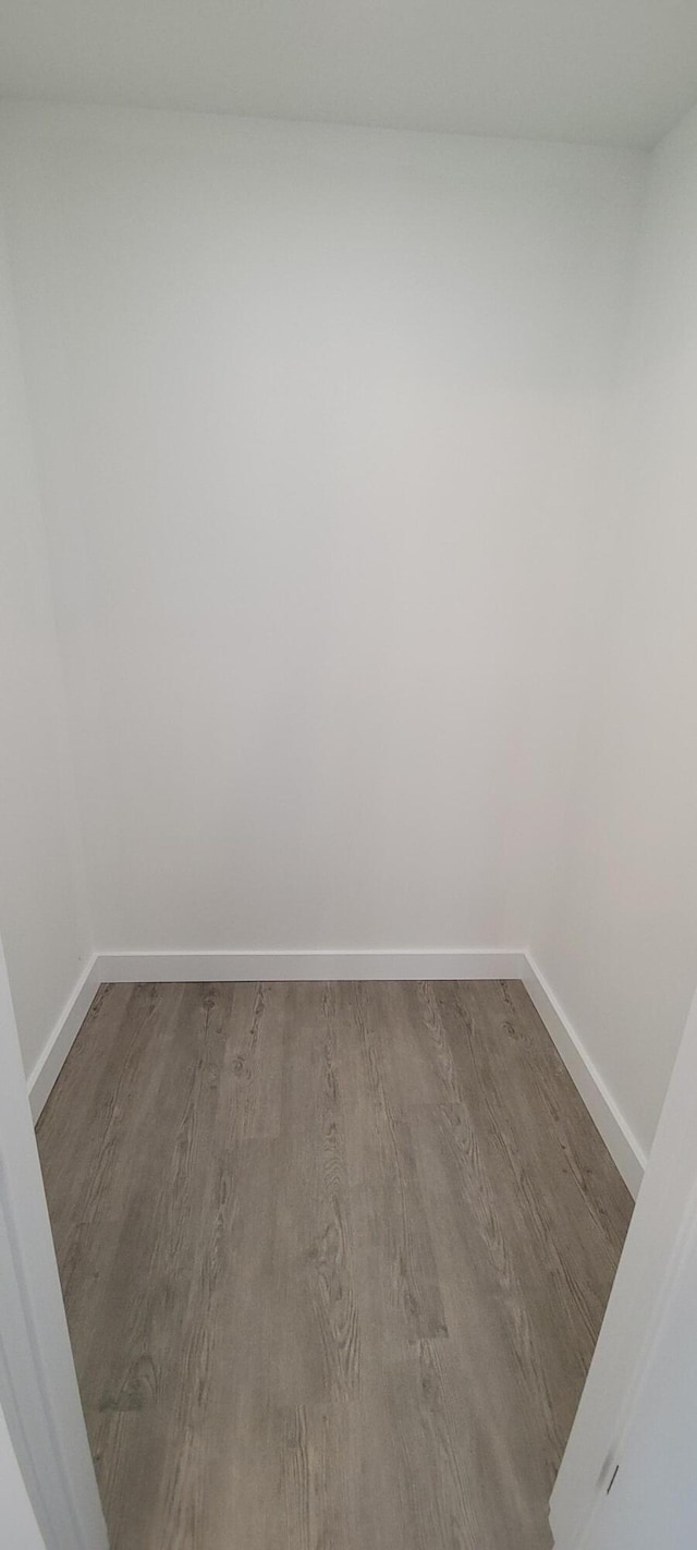 empty room with wood finished floors and baseboards