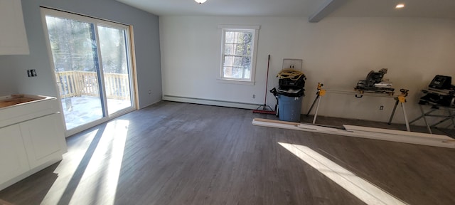 interior space featuring wood finished floors, baseboard heating, and a sink