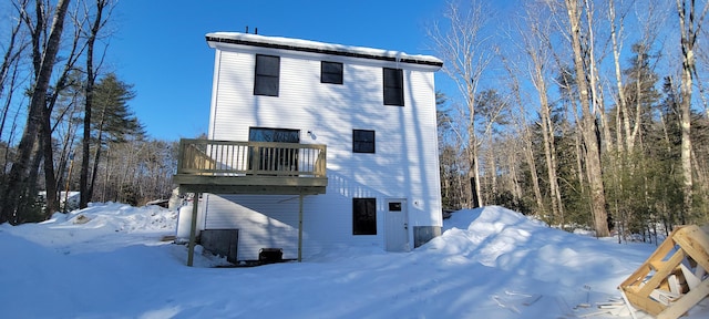 view of snow covered rear of property