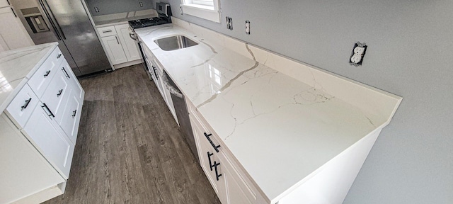 kitchen featuring dark wood-style floors, white cabinets, light stone countertops, and stainless steel fridge with ice dispenser