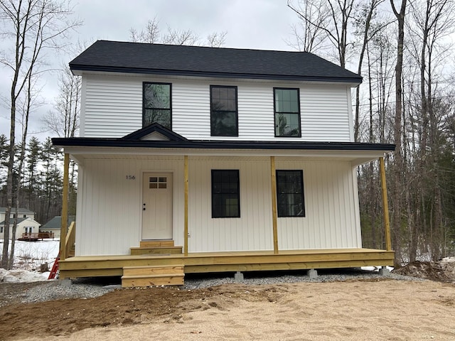 view of front of home featuring entry steps, covered porch, and a shingled roof