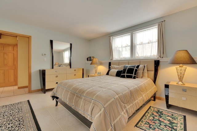 bedroom featuring light tile patterned flooring and baseboards