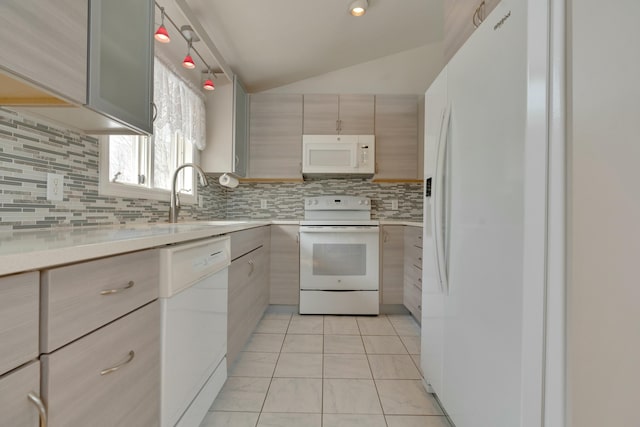 kitchen with white appliances, light countertops, tasteful backsplash, and a sink