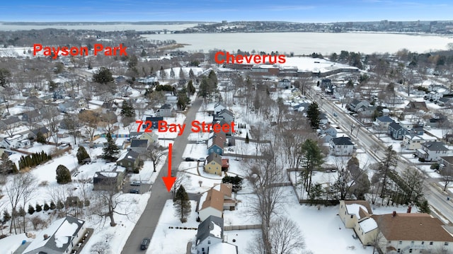 snowy aerial view with a residential view