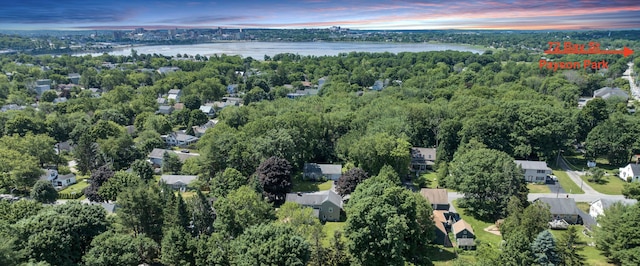 aerial view at dusk featuring a water view