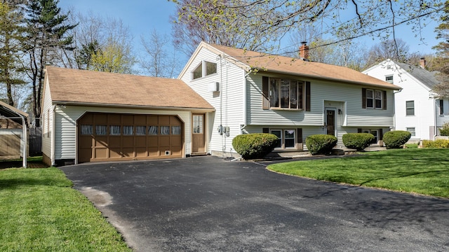 72 Bay St, Portland, ME 04103 - raised ranch with roof with shingles, a garage, a front yard, a chimney, and driveway