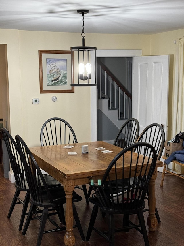 dining space featuring stairway and dark wood finished floors