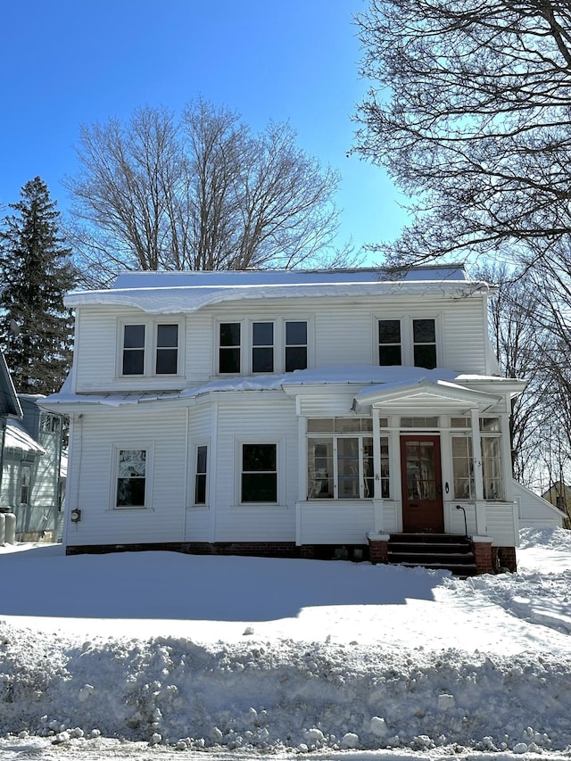 view of front of home featuring a sunroom