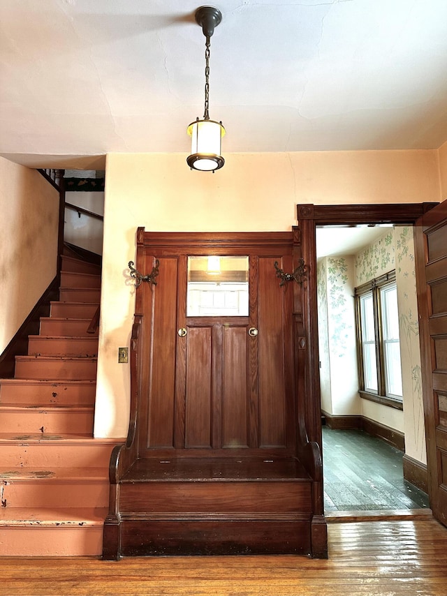 interior space with wallpapered walls, stairs, baseboards, and hardwood / wood-style floors