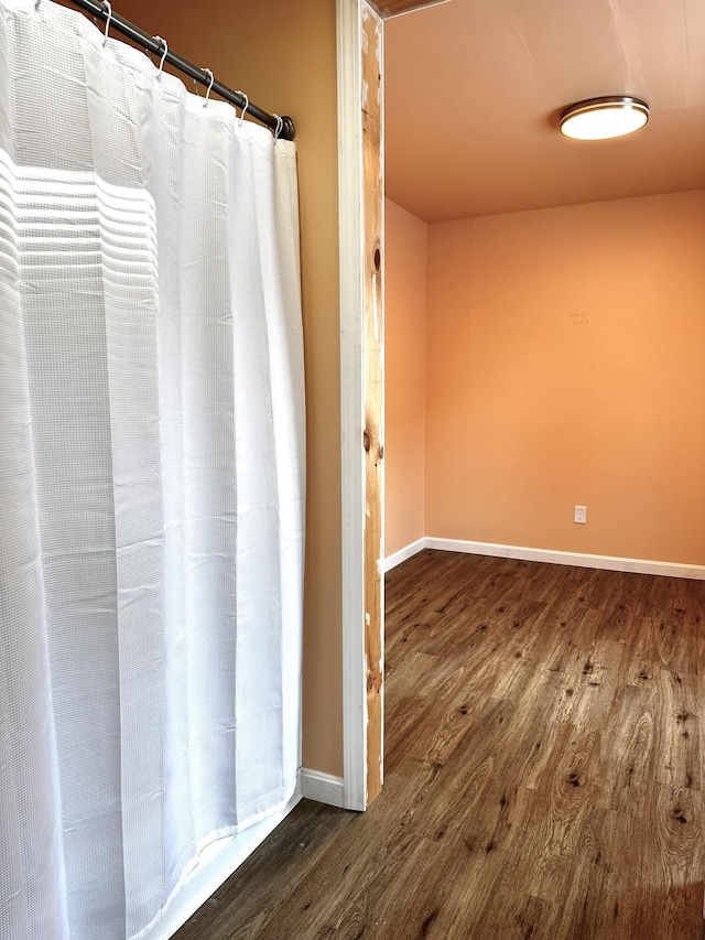 bathroom with baseboards and wood finished floors