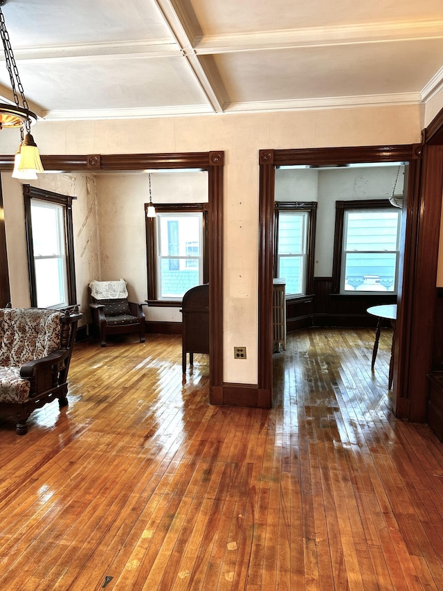 interior space with beam ceiling, coffered ceiling, baseboards, and wood-type flooring