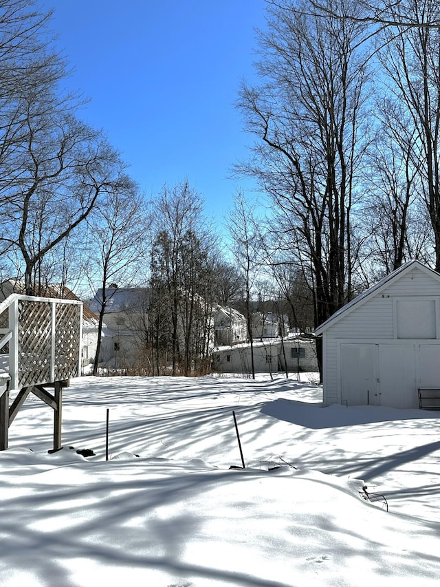 yard covered in snow with an outdoor structure