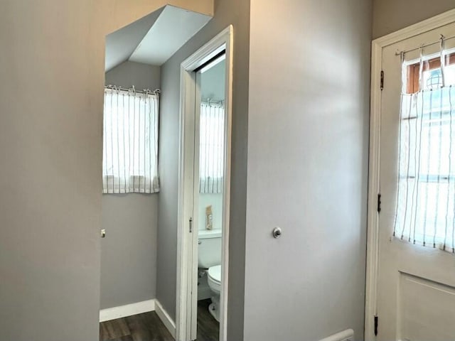 bathroom with toilet, wood finished floors, and baseboards