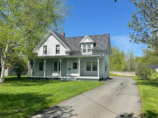 4 Blockhouse Rd, Fort Kent, ME 04743 - view of front of house with a porch, asphalt driveway, a shingled roof, and a chimney