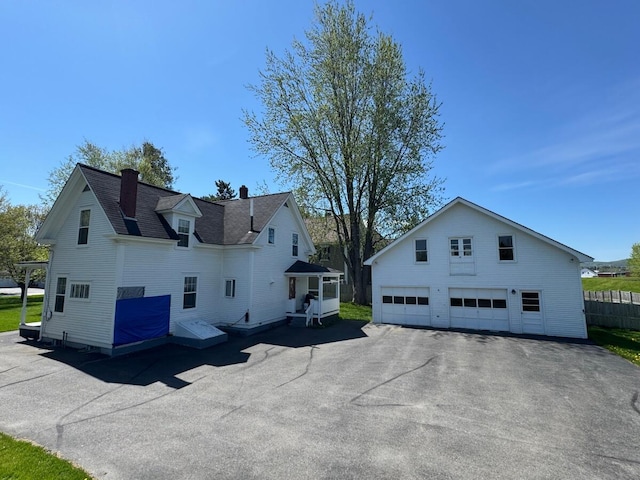 4 Blockhouse Rd, Fort Kent, ME 04743 - view of home's exterior with a garage, a chimney, and an outdoor structure