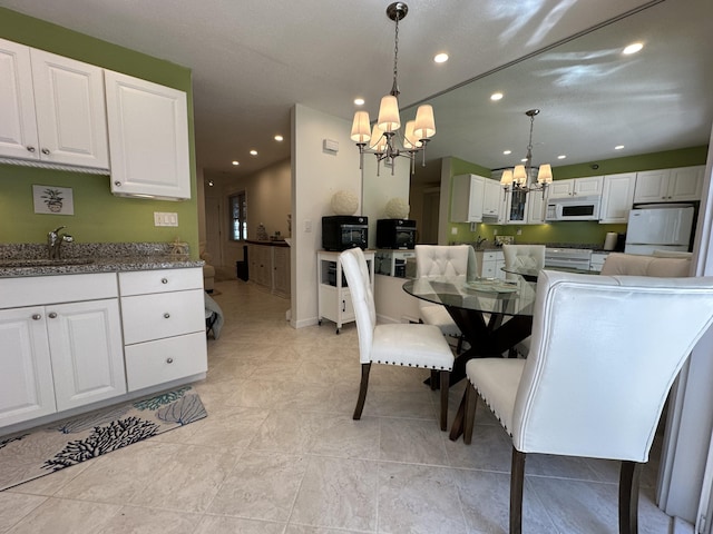 dining space with a chandelier and recessed lighting