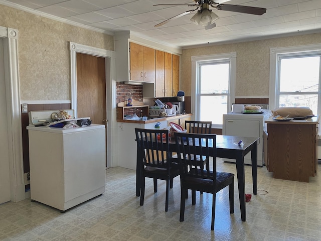 dining area featuring washer / clothes dryer, a healthy amount of sunlight, and light floors