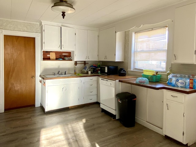 kitchen with white cabinets, white dishwasher, a sink, and wood finished floors