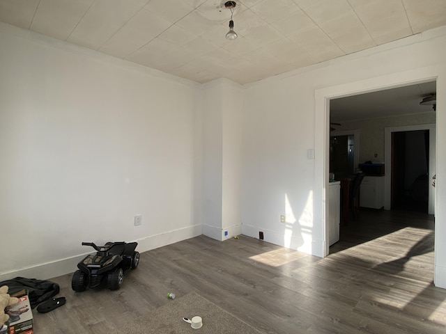 unfurnished room featuring baseboards and wood finished floors