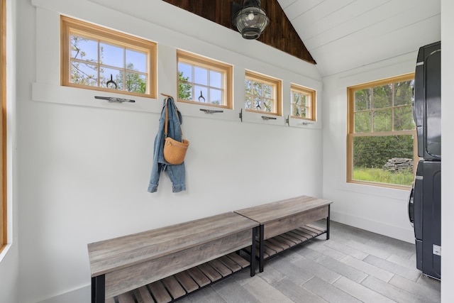 463 Back Meadow Rd, Damariscotta, ME 04543 - mudroom with stacked washer / drying machine, lofted ceiling, plenty of natural light, and baseboards