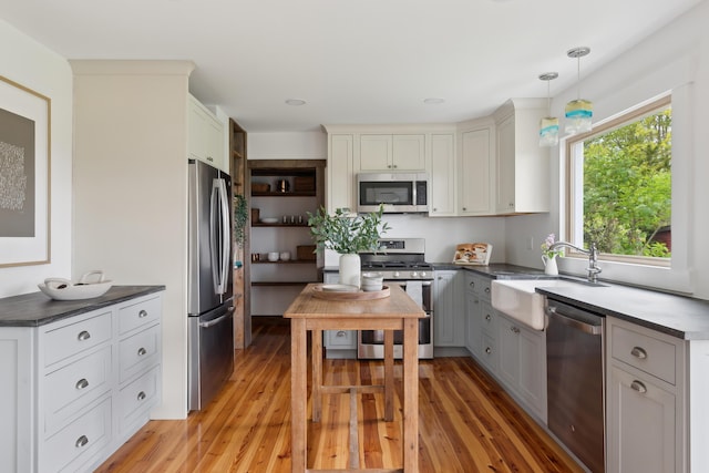 463 Back Meadow Rd, Damariscotta, ME 04543 - kitchen featuring appliances with stainless steel finishes, a sink, dark countertops, and light wood finished floors