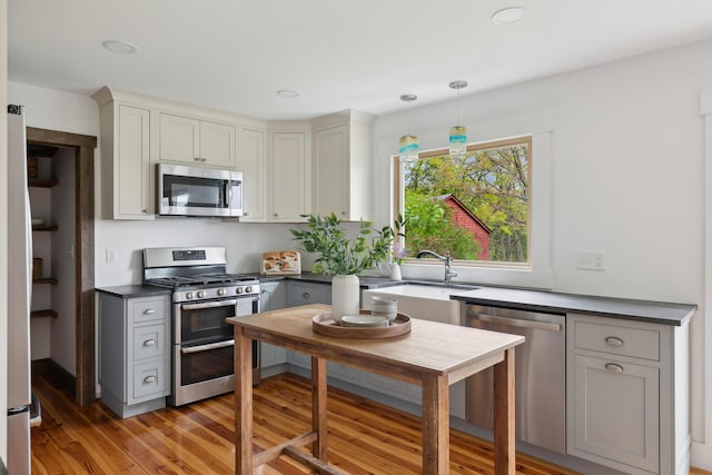 463 Back Meadow Rd, Damariscotta, ME 04543 - kitchen featuring appliances with stainless steel finishes, dark countertops, a sink, gray cabinetry, and light wood finished floors