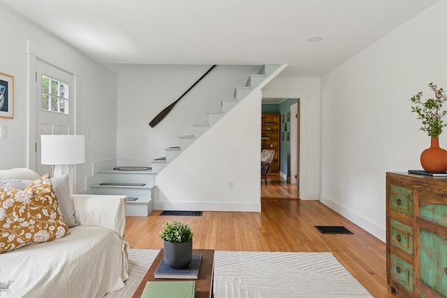 463 Back Meadow Rd, Damariscotta, ME 04543 - living area featuring stairway, hardwood / wood-style floors, and baseboards