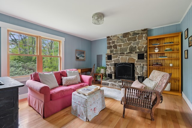 463 Back Meadow Rd, Damariscotta, ME 04543 - living room featuring crown molding, hardwood / wood-style floors, and a stone fireplace