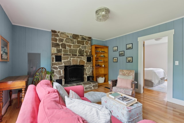 463 Back Meadow Rd, Damariscotta, ME 04543 - living room featuring crown molding, wood finished floors, a stone fireplace, and electric panel