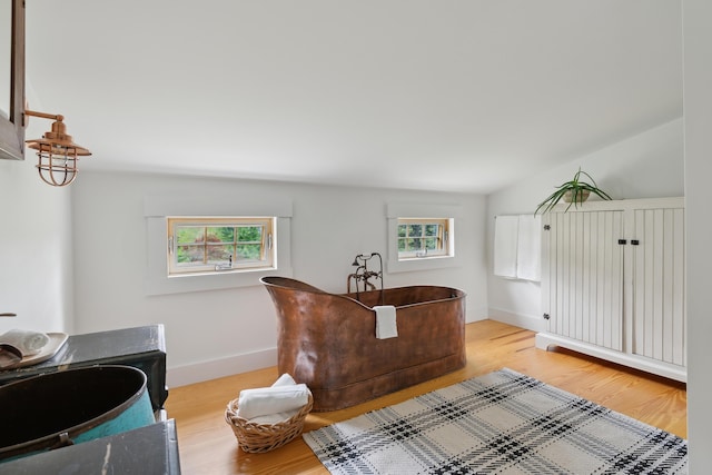 463 Back Meadow Rd, Damariscotta, ME 04543 - full bath with a freestanding bath, wood finished floors, baseboards, and vaulted ceiling