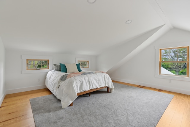 463 Back Meadow Rd, Damariscotta, ME 04543 - bedroom featuring multiple windows, lofted ceiling, wood finished floors, and baseboards