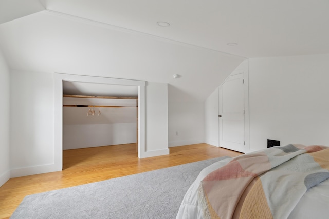 463 Back Meadow Rd, Damariscotta, ME 04543 - bedroom featuring vaulted ceiling, light wood-style flooring, baseboards, and a walk in closet