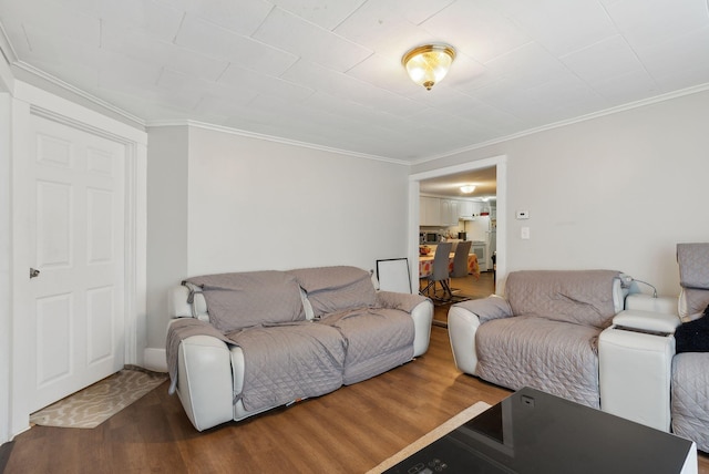 living area with crown molding and wood finished floors