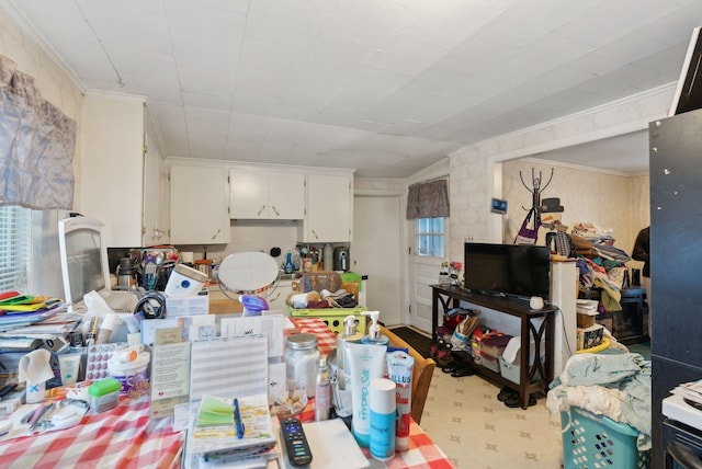 kitchen featuring white cabinetry, tile patterned floors, and ornamental molding