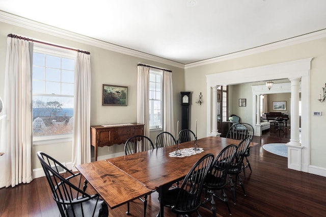 dining area featuring decorative columns, crown molding, baseboards, and dark wood-type flooring