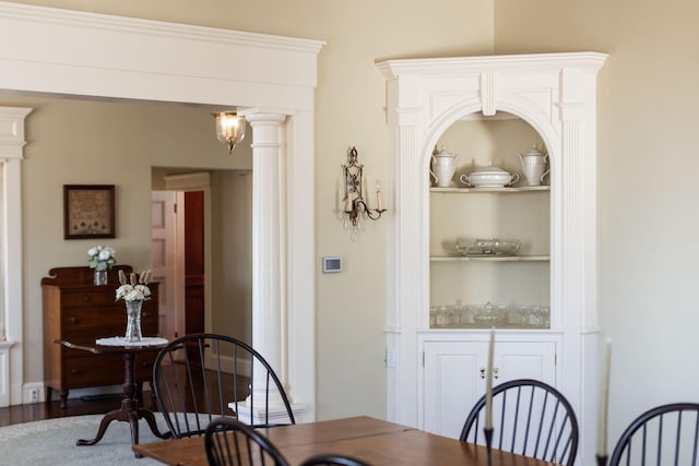 dining space featuring ornate columns