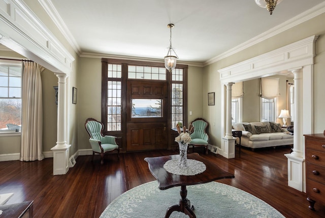 foyer with baseboards, ornamental molding, dark wood finished floors, and ornate columns