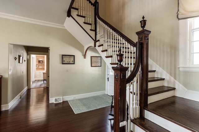 stairs featuring baseboards, visible vents, ornamental molding, and wood finished floors