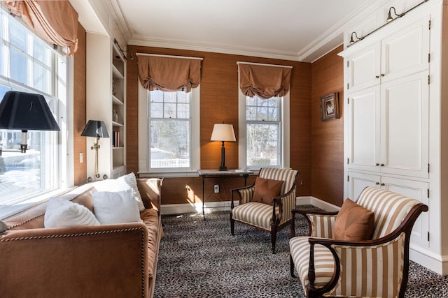 living area featuring ornamental molding, built in shelves, and baseboards