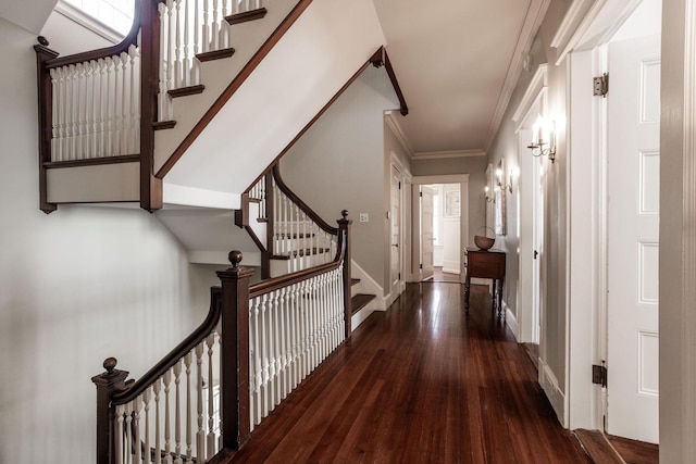 hall featuring baseboards, stairs, hardwood / wood-style flooring, and crown molding