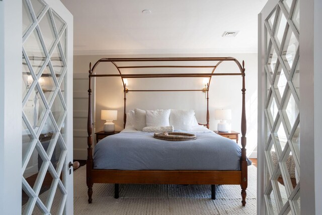 bedroom featuring ornamental molding and visible vents