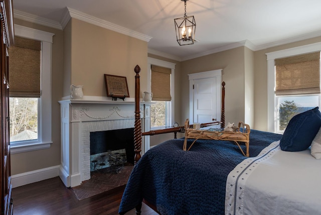 bedroom with baseboards, dark wood-style flooring, a fireplace, and crown molding