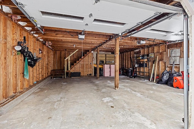 garage with separate washer and dryer and a garage door opener