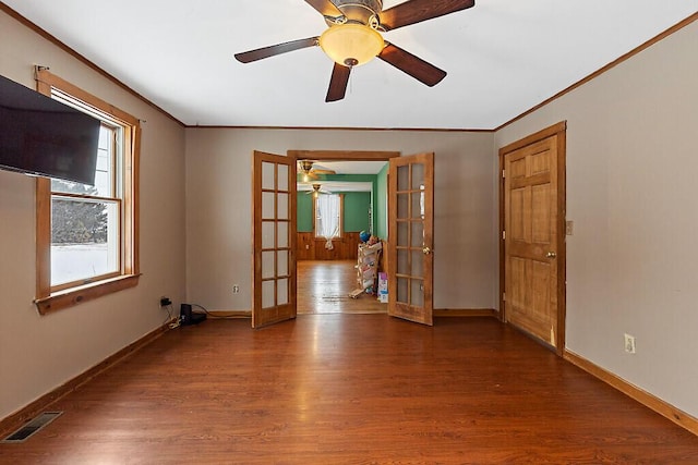 spare room with french doors, wood finished floors, visible vents, and baseboards